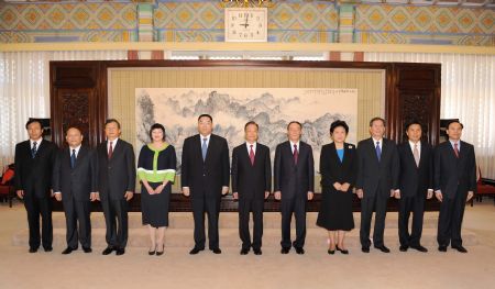 Chinese Premier Wen Jiabao (6th, L) and Chui Sai On (5th L), the new chief executive of the Macao Special Administrative Region (SAR), pose for a group photograph in Beijing, capital of China, on Aug. 11, 2009. Wen awarded the instrument of appointment as the new chief executive of the Macao SAR to Chui Sai On on Tuesday.