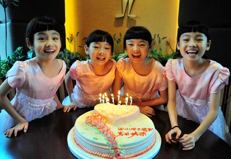 The quadruplet sisters Zhu Wanbing, Zhu Wanqing, Zhu Wanyu and Zhu Wanjie (from L to R) celebrate their 10th birthday at a restaurant in Nanjing, east China's Jiangsu Province, Aug. 11, 2009. The quardruplet sisters were naturally conceived and born on August 11, 1999 in Nanjing. (Xinhua/Yao Qiang)