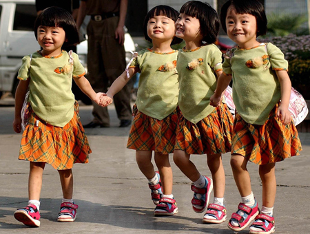 The quadruplet sisters Zhu Wanbing, Zhu Wanqing, Zhu Wanyu and Zhu Wanjie are seen in a picture taken on September 1, 2002, walking hands in hands for their first kindergarden day in Nanjing, east China's Jiangsu Province. The quardruplet sisters were naturally conceived and born on August 11, 1999 in Nanjing. (Xinhua/Yao Qiang)