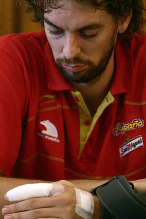Spain's Pau Gasol looks at his injured finger during a news conference in San Fernando, southern Spain, August 11, 2009.