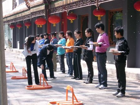 A restaurant trains employees to carry serving trays.(Photo Source:Chinadaily.com)
