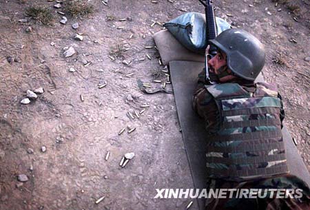 An Afghan soldier prepares to fire an M-16 rifle during a training session by U.S. forces in Honaker Miracle camp at the Pesh Valley, Kunar Province August 10, 2009. The Afghan National Army has started the process of changing weapons from the old AK-47 to the American M-16 rifle.