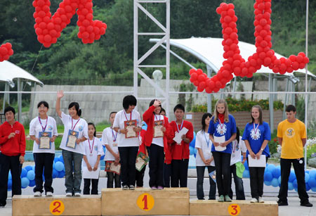 Russian and Chinese children receive athletic competition awards during a soiree at the 