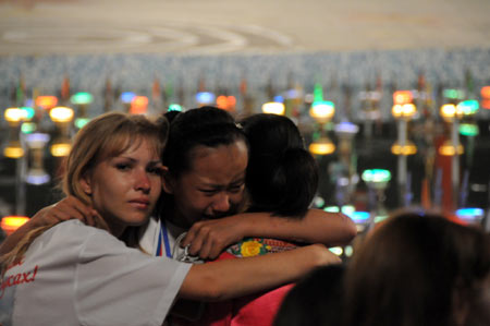 Chinese children hug their Russian counsellors at the 