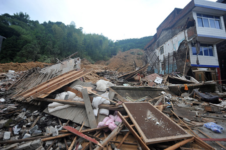 The picture taken on August 11, 2009, shows the site of a landslide at Pengxi Township in Taishun County, east China's Zhejiang Province. Two people died and four were injured in a storm-induced landslide late Monday here. The landslide occurred at around 10:21 p.m., after five straight days of continuous rain brought by Typhoon Morakot. [Wang Dingchang/Xinhua]