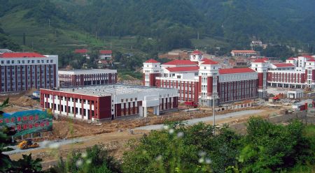 A panoramic view of the campus of Tianjin High Middle School is seen in the picture taken in Lueyang, northwest China's Shaanxi province, Aug. 12, 2009. The high middle school with its designed capacity of 3,000 students was donated by the people and government of North China's Tianjin Municipality after the serious earthquake hit southwest China's Sichuan province, northwest China's Shaanxi and Gansu provinces on May 12, 2008.(Xinhua/Wang Wei) 