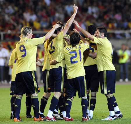 Spain's players celebrate after scoring against Macedonia during their international friendly soccer match in Skopje August 12, 2009.