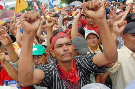 Supporters of ousted Honduran President Manuel Zelaya take part in a protest in Tegucigalpa, capital of Honduras, Aug. 11, 2009. Thousands of supporters of ousted Honduran President Manuel Zelaya converged on the capital Tegucigalpa on Tuesday to demand his restitution as president of the country.