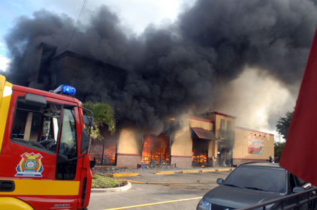 Smoke rises from a burning restaurant after supporters of ousted Honduran President Manuel Zelaya set it on fire in Tegucigalpa, capital of Honduras, Aug. 11, 2009.