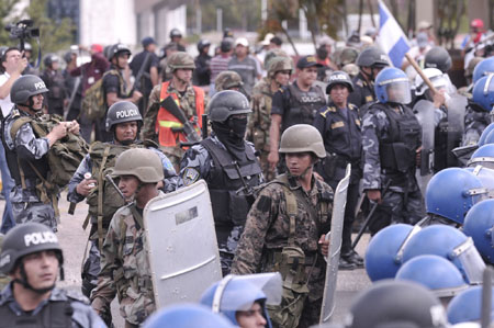 Supporters of ousted Honduran President Manuel Zelaya confront Honduran police in Tegucigalpa, capital of Honduras, Aug. 11, 2009. 