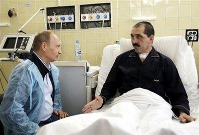 Russian Prime Minister Vladimir Putin (L) talks to Ingush leader Yunus-Bek Yevkurov in a Moscow hospital in late July 2009. Yevkurov was seriously wounded in a bombing in June 2009. In a new incident, the minister of construction in Russia's turbulent Ingushetia region, Ruslan Amerkhanov, has been shot dead inside his ministerial office, officials said.[Aleksey Nikolskyi/CCTV/AFP/RIA Novosti/File] 