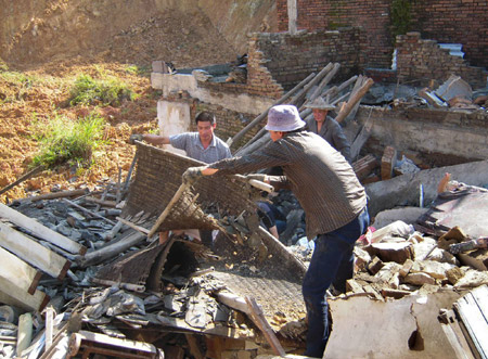 Dewellers clear remains of their houses at Meiyang Village in Zherong County, southeast China's Fujian Province, Aug. 13, 2009. Typhoon Morakot has killed at least three people and caused direct economic loss of almost 2 billion RMB yuan (292 million U.S. dollars) in Fujian as of Wednesday afternoon, after a powerful landing in east China on Sunday. (Xinhua/Pan Wenshu) 