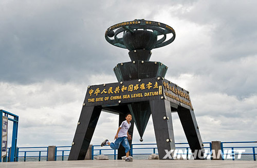 A boy plays at China's zero sea-level marker in Qingdao on August 11, 2009.