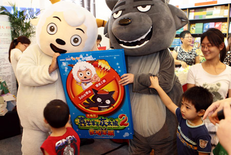 Children pose for a photo with people dressed as cartoon characters from the famous cartoon series "Pleasant Goat and Big Big Wolf" at the book fair at the Shanghai Exhibition Center in Shanghai, east China, on Aug. 13, 2009. Opened here on Thursday, the week-long 2009 Shanghai Book Fair would attract about 470 publishers and feature over 300 cultural events. (Xinhua/Liu Ying) 