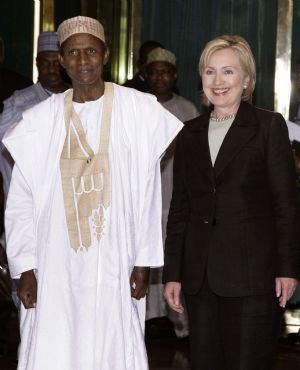 U.S. Secretary of State Hillary Clinton (R) and Nigerian President Umaru Yar'Adua pose for photographers at the state house in Abuja August 12, 2009. Clinton's wraps up her Africa trip on Friday, urging nations such as Nigeria and Kenya to tackle graft but showing no big policy shifts by the Obama administration towards the continent. Picture taken August 12, 2009. 