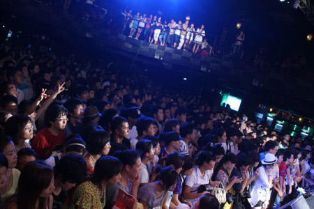 Audiences listen as a singer sings a song by the deceased American singer Michael Jackson at a charity concert held in the Star Live in Beijing, capital of China, August 12, 2009.