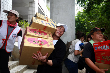 Chinese actor Jet Li (2nd L front) carries relief goods with volunteers in Liukuei Town of Kaohsiung in southeast China's Taiwan, Aug. 15, 2009. The One Foundation Project, initiated by Jet Li, had allocated 300,000 yuan (about 43,800 U.S. dollars) to Taiwan for typhoon relief, the foundation said Sunday.(Xinhua Photo)