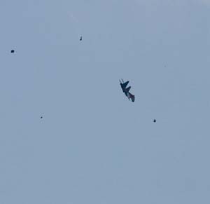 Fragments seen flying, from a two-seat Su-27 jet from the Russian air force elite aerobatic team Russkiye Vityazi (Russian Knights), just seconds after the aircraft collided with a single-seat Su-27, not seen, not far from the Zhukovsky airfield, east of Moscow, Sunday, Aug. 16, 2009. 
