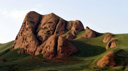 Photo taken on Aug. 14, 2009 shows a part of scenery of the Huoshizhai National Geopark in northwest China's Ningxia Hui Autonomous Region. The geopark is famous for its unique 'Danxia' landform. Danxia, which means 'rosy cloud', is a kind of special landform formed from reddish sandstone that has been eroded over time into a series of mountains surrounded by curvaceous cliffs and many unusual rock formations. (Xinhua/Liu Quanlong) 