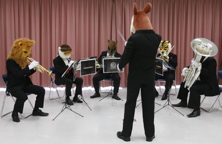 Professional musicians wearing animal masks perform during their rehearsal at the Zoorasia zoo in Yokohama, near Tokyo, August 16, 2009. The band named Zoorasian Brass aims to increase interest in classic music amongst children, organizer said.