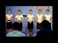 Candidates wait for the interview for air hostess of the China Southern Airlines on August 15 in Beijing. More than 6,000 candidates joined the selection activity in Beijing selection area for the position. Those who are chosen will serve on the flight during the 2010 Guangzhou Asian Games. Some 400 air hostesses will be selected from 7 selection regions throughout China. (China.org.cn/CFP)