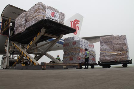 Working staff examine the relief supplies at the Beijing Capital International Airport, China, on Aug. 18, 2009. (Xinhua/Xing Guangli)