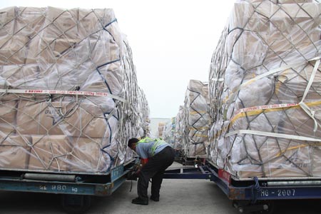 A working staff examines the relief supplies at the Beijing Capital International Airport, China, on Aug. 18, 2009. The Chinese mainland will send its second batch of disaster relief materials to typhoon Morakot hit Taiwan by air on Tuesday afternoon by a special plane directly from the Beijing Capital International Airport to Kaohsiung. The materials include more than 10,000 sleeping bags, 10,000 blankets and 1,000 sterilizing machines. (Xinhua/Xing Guangli)