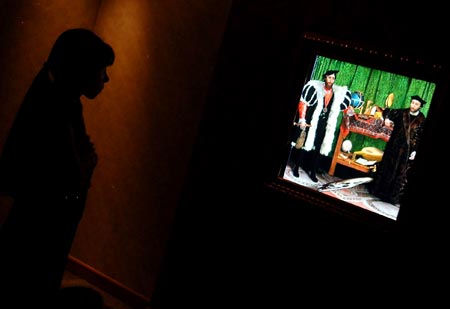 A visitor watches a digital version of the painting The Ambassadors at an exhibition in Beijing, capital of China, Aug. 18, 2009. The exhibition displayed many masters' paintings in digital version, which demonstrated stories behind the masterpieces through interactive multimedia technology.