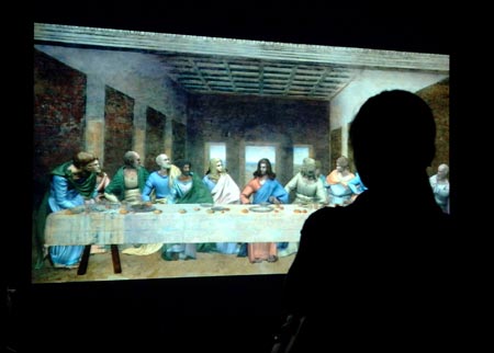 A visitor watches a digital version of Leonardo da Vinci's Last Supper at an exhibition in Beijing, capital of China, Aug. 18, 2009. The exhibition displayed many masters' paintings in digital version, which demonstrated stories behind the masterpieces through interactive multimedia technology.