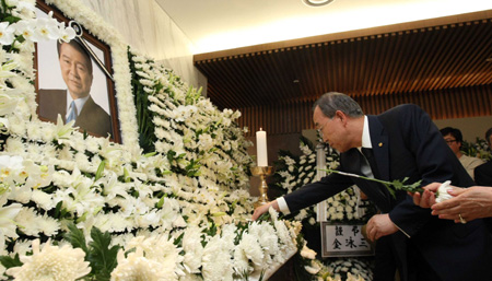 U.N. Secretary General Ban Ki-moon offers flowers to the portrait of former South Korean President Kim Dae-jung at the memorial room of Severance Hospital in Seoul, South Korea on Aug. 18, 2009.