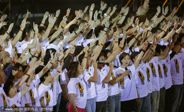 Hong Kong singers and actors perform along with other Asian entertainers during the 'Artistes 88 Fund Raising Campaign ' at the AsiaWorld-Expo in Hong Kong Monday, Aug. 17, 2009.