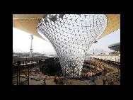 A view of the illuminateed Expo Axis, known as the 'Sunny Valleys' is seen at the 2010 World Expo site in Shanghai on August 17, 2009. The funnelshaped structures can divert sunlight into underground rooms and collect rainwater for recycling. The Sunny Valleys are on a major passage that links the Expo's main theme pavilions.(China.org.cn / CFP)