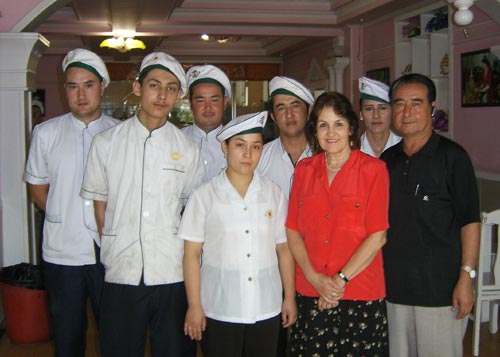Lisa(Front M), Tursun(R), and his restaurant staff. [Foreign Languages Press]