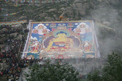 A giant tangka, displaying the image of Sakyamuni, the founder of Buddhism, was unveiled in Drepung Monastery in Lhasa, Tibet Autonomous Region's capital, on Thursday morning, August 20, 2009. The week-long Shoton Festival kicked off in Lhasa on Thursday. [Photo: Jia Changfei/CFP] 