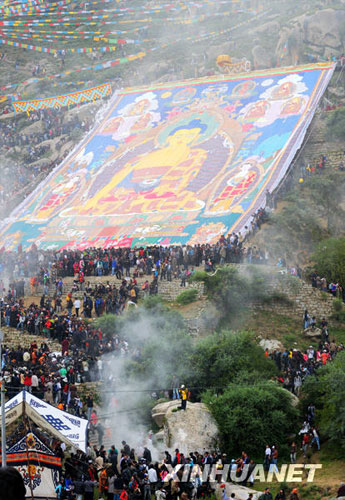 A giant tangka, displaying the image of Sakyamuni, the founder of Buddhism, was unveiled in Drepung Monastery in Lhasa, Tibet Autonomous Region's capital, on Thursday morning, August 20, 2009. The week-long Shoton Festival kicked off in Lhasa on Thursday. [Photo: Jia Changfei/CFP] 