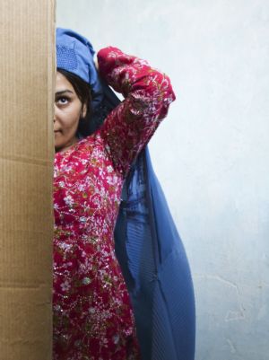 An Afghan woman is pictured in a voting booth at a polling centre in Herat, western Afghanistan August 20, 2009.[Xinhua/Reuters]