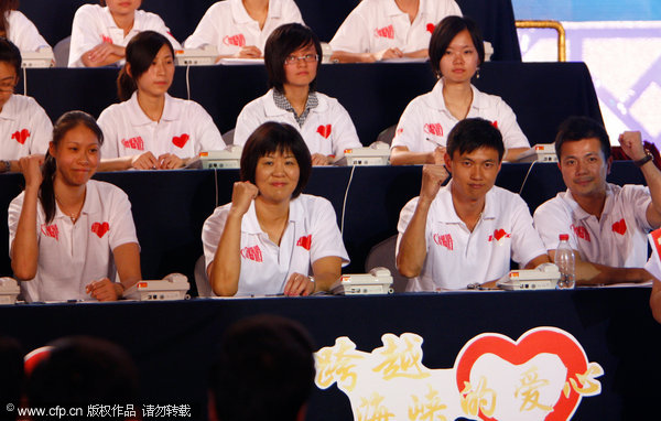 Sport stars renowned Chinese volleyball player Zhao Ruirui (L), volleyball coach Lang Ping (second from the left), Olympic fencing champion Zhong Man (second from the right) and Olympic weightlifting champion Zhang Xiangxiang (R) show their determination to help the victims in Taiwan. Stars work as volunteer telephone operator at the fundraiser.