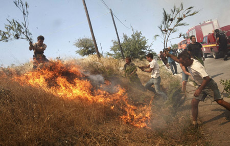 Big fires occurred in Marathon area close to Greek capital on Saturday, threatening the villages and Penteli mountain nearby. No injuries were reported so far.