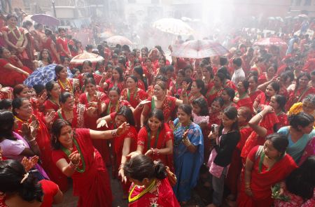 Hindu women take part in a traditional dance at Pashupati Nath Temple during celebrations of the 'Teej' festival in Kathmandu August 23, 2009. Married Hindu women wearing red bridal dresses to celebrate the 'Teej'' festival for to pray for a long life and the well-being of their husbands. Unmarried women observe the festival by praying for a good husband.[Xinhua/Reuters]