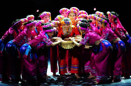 Actresses from Guangxi Dancing School dance during a charity performance of the ongoing 9th 'Taolibei' National Dancing Competition in Shenyang, capital of northeast China's Liaoning Province, Aug. 22, 2009. [Xinhua]