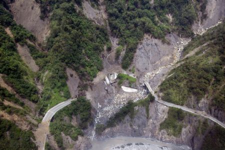 Photo taken on Aug. 24, 2009 shows the severely-damaged Nanheng Road section across the Taoyuan Village of Kaohsiung County, southeast China's Taiwan.[Xinhua]