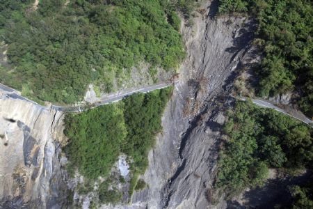 Photo taken on Aug. 24, 2009 shows the severely-damaged Nanheng Road section across the Taoyuan Village of Kaohsiung County, southeast China's Taiwan.[Xinhua]