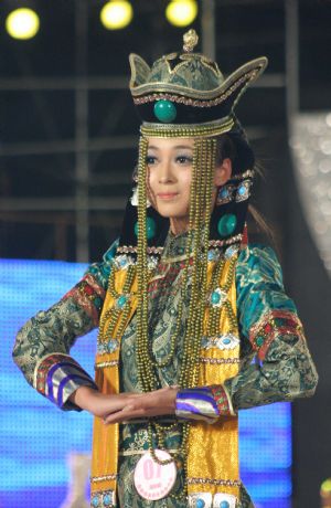 A contestant presents a Mongolian costume during the final of 2009 New Silk Road China Inner Mongolia Model Competition in Hohhot, capital of north China's Inner Mongolia Autonomous Region, Aug. 23, 2009. 