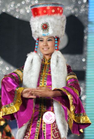 A contestant presents a Mongolian costume during the final of 2009 New Silk Road China Inner Mongolia Model Competition in Hohhot, capital of north China's Inner Mongolia Autonomous Region, Aug. 23, 2009. 