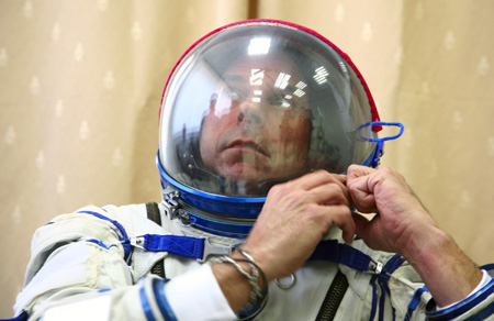 Guy Laliberte prepares for exercises during a training session in the International Space Station (ISS) at the Star City space centre outside Moscow, August 25, 2009.[Xinhua/Reuters]