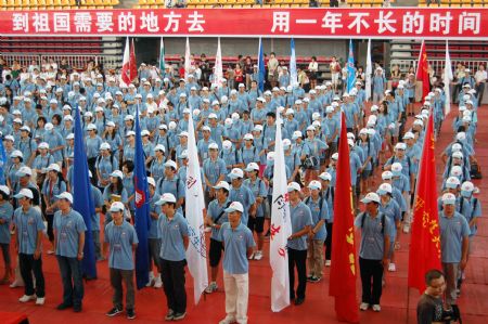 Postgraduate volunteers who are about to set out on their obligation as assisting tutors attend the setting-off ceremony, in Guiyang, southwest China's Guizhou Province, Aug. 25, 2009.[Xinhua]