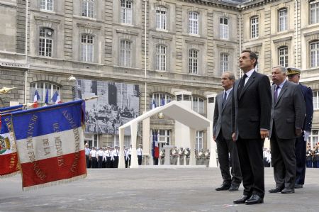 France's President Nicolas Sarkozy (2nd L), accompanied by French Junior Minister for Veterans' affairs Hubert Falco (L) and Senate President Gerard Larcher, attends a ceremony at the Paris prefecture, August 25, 2009.[Xinhua/Reuters]