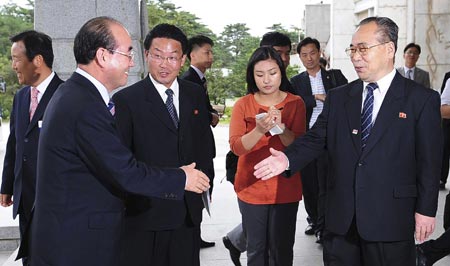 Kim Young-chel (L), chief delegate and secretary general of the South Korean Red Cross office, is greeted by his DPRK counterpart Choe Song-ik (R) upon Kim's arrival at Mount Kumgang hotel in Mt. Kumgang of DPRK August 26, 2009.