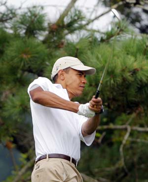 U.S. President Barack Obama watches his tee shot while golfing at Mink Meadows golf course in Tisbury, Massachusetts on the Island of Martha's Vineyard August 25, 2009.