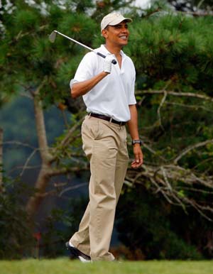 U.S. President Barack Obama watches his tee shot while golfing at Mink Meadows golf course in Tisbury, Massachusetts on the Island of Martha's Vineyard August 25, 2009. 